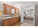 Bathroom featuring double sinks and vanity, with an adjoining bedroom at 4403 Jeffries Rd, Durham, NC 27704