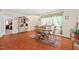 Bright dining room with hardwood floors, a chandelier, and a table set for six, connecting to other living spaces at 4403 Jeffries Rd, Durham, NC 27704
