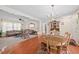 Open-concept space with dining and living areas, featuring hardwood floors, carpet, and natural light, creating a welcoming atmosphere at 4403 Jeffries Rd, Durham, NC 27704