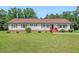 Charming ranch-style home with red shutters, a well-manicured lawn, and mature trees, perfect for a serene living at 4403 Jeffries Rd, Durham, NC 27704