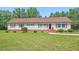 Charming ranch-style home with red shutters, a well-manicured lawn, and mature trees, perfect for a serene living at 4403 Jeffries Rd, Durham, NC 27704