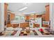 Well-lit eat-in kitchen featuring wooden cabinets, white appliances, and a breakfast nook at 4403 Jeffries Rd, Durham, NC 27704