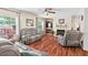 Bright living room with large windows, a fireplace, hardwood floors and comfortable seating at 4403 Jeffries Rd, Durham, NC 27704