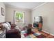 Cozy living room with a comfortable leather sofa and large window at 4403 Jeffries Rd, Durham, NC 27704