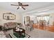 Spacious living area seamlessly connects to the dining room, with cozy furniture and a ceiling fan, ideal for relaxation at 4403 Jeffries Rd, Durham, NC 27704