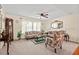 Bright living room featuring a floral sofa set, ceiling fan, carpet, and natural light, creating an inviting atmosphere at 4403 Jeffries Rd, Durham, NC 27704