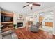Cozy living room showcasing a fireplace, built-in shelving, and an open layout to the kitchen at 4403 Jeffries Rd, Durham, NC 27704