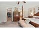 Primary bedroom with a four-poster bed, bench seating, and access to walk-in closet and bathroom at 4403 Jeffries Rd, Durham, NC 27704