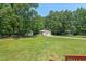 This home's property includes outbuildings, mature trees and an expansive lawn at 4403 Jeffries Rd, Durham, NC 27704