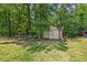 Picturesque shed nestled among mature trees, perfect for a workshop or storage at 4403 Jeffries Rd, Durham, NC 27704