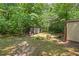 Additional storage shed in a wooded area, offering versatile outdoor space at 4403 Jeffries Rd, Durham, NC 27704
