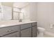 Bathroom featuring a large mirror, grey vanity, and a toilet at 503 Gateway Townes Blvd, Wake Forest, NC 27587