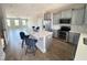 Bright kitchen with gray cabinets, stainless appliances, island with seating, and open to living area at 503 Gateway Townes Blvd, Wake Forest, NC 27587