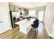 Modern kitchen featuring stainless steel appliances, light gray cabinetry, and an island with seating at 503 Gateway Townes Blvd, Wake Forest, NC 27587