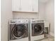 Convenient laundry room with modern washer and dryer units, plus storage cabinets at 503 Gateway Townes Blvd, Wake Forest, NC 27587