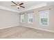 Large main bedroom with carpet, a tray ceiling with fan, and natural light from three windows at 503 Gateway Townes Blvd, Wake Forest, NC 27587