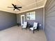 Relaxing covered patio with ceiling fan and seating area at 503 Gateway Townes Blvd, Wake Forest, NC 27587