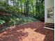 Spacious backyard featuring a terraced landscape, offering a private and serene outdoor space at 5105 Carolwood Ln, Durham, NC 27713