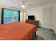 Bright bedroom featuring a ceiling fan, carpeted floor and a large window with backyard view at 5105 Carolwood Ln, Durham, NC 27713