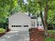 Charming two-story home featuring a two-car garage and a meticulously maintained front yard at 5105 Carolwood Ln, Durham, NC 27713