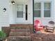 Inviting entrance featuring brick steps and chairs creating a welcoming ambiance at 5105 Carolwood Ln, Durham, NC 27713