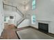 Bright living room features a fireplace, hardwood floors, and a staircase leading to the second floor at 5105 Carolwood Ln, Durham, NC 27713