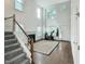 Open-concept living room with hardwood floors, fireplace, and a staircase at 5105 Carolwood Ln, Durham, NC 27713