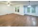 Spacious living room featuring hardwood floors, large windows with natural light, and a ceiling fan at 5105 Carolwood Ln, Durham, NC 27713