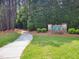 Welcoming Greenbriar community signage surrounded by lush greenery, creating a warm ambiance at 5105 Carolwood Ln, Durham, NC 27713