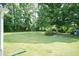 A big backyard with lush greenery and a shed, perfect for outdoor activities at 523 Edwards Rd, Henderson, NC 27537