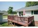 Cozy backyard deck with a grill, dining table, and comfortable seating, perfect for entertaining at 523 Edwards Rd, Henderson, NC 27537