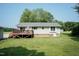 Charming backyard with a spacious deck, lush lawn, and mature trees, ideal for outdoor living at 523 Edwards Rd, Henderson, NC 27537