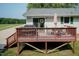 A spacious deck with a grill, patio furniture, and stairs leading to the yard at 523 Edwards Rd, Henderson, NC 27537