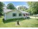 Charming single-story home with a front porch, green shutters, and a well-maintained lawn at 523 Edwards Rd, Henderson, NC 27537