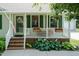 Inviting front porch decorated with flowers, offering a cozy space to enjoy the outdoors at 523 Edwards Rd, Henderson, NC 27537