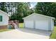 Spacious two-car detached garage with adjacent deck and mature trees offers privacy at 523 Edwards Rd, Henderson, NC 27537