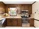 A functional kitchen offers stainless appliances, ample counter space and cabinetry at 523 Edwards Rd, Henderson, NC 27537