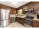 Well-equipped kitchen with stainless steel appliances and dark wood cabinetry at 523 Edwards Rd, Henderson, NC 27537
