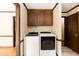Convenient laundry room boasts modern washer and dryer, and overhead storage cabinets at 523 Edwards Rd, Henderson, NC 27537