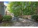 Inviting backyard with a stone patio and a wooden fence surrounded by lush greenery at 5405 Swordsman Ct, Knightdale, NC 27545
