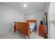 Cozy bedroom featuring a wooden bed frame and a dresser near the window at 5405 Swordsman Ct, Knightdale, NC 27545