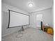 Spacious room with a projection screen, window, and a small side table at 5405 Swordsman Ct, Knightdale, NC 27545