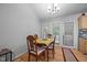 Cozy dining area featuring hardwood floors, backyard views, and a classic light fixture at 5405 Swordsman Ct, Knightdale, NC 27545