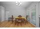 Bright dining room with natural light, hardwood floors, and a neutral color palette at 5405 Swordsman Ct, Knightdale, NC 27545