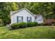 Side exterior of a home with landscaped yard, tidy shrubbery, and attached garage at 5405 Swordsman Ct, Knightdale, NC 27545