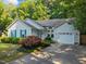 Exterior view of home showcasing landscaped front yard and attached garage on sunny day at 5405 Swordsman Ct, Knightdale, NC 27545