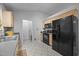 Bright kitchen with tile floors, wood cabinets, black appliances and plenty of room at 5405 Swordsman Ct, Knightdale, NC 27545