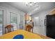 Cozy kitchen and dining area with tile floors, wood cabinets and a black refrigerator at 5405 Swordsman Ct, Knightdale, NC 27545
