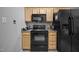 Kitchen with black appliances, wood cabinets, and gray countertop at 5405 Swordsman Ct, Knightdale, NC 27545