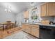 Kitchen with bright window, wood cabinets, and view to the dining area at 5405 Swordsman Ct, Knightdale, NC 27545